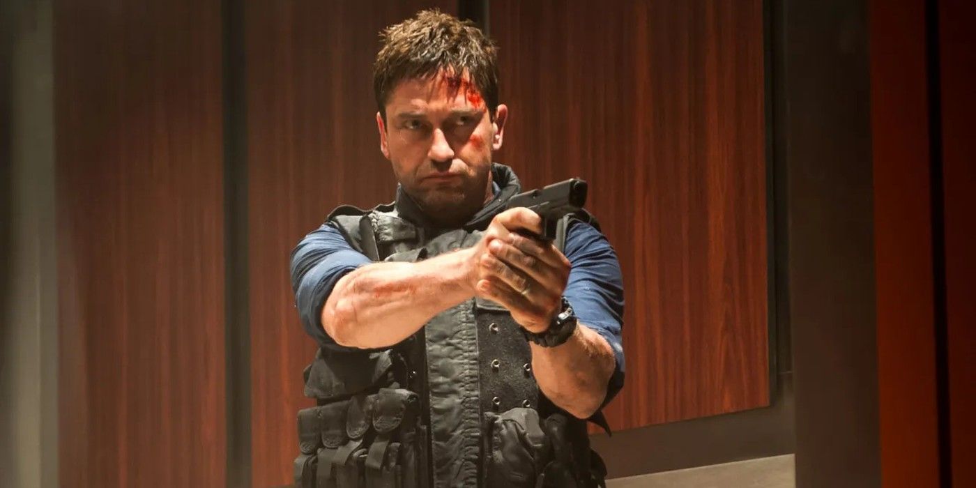 gerard butler as a bloodied mike banning pointing a gun in olympus has falle